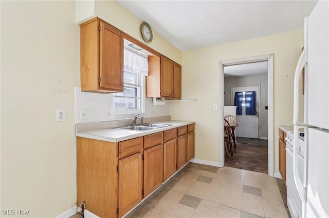 kitchen with sink, white fridge, and backsplash