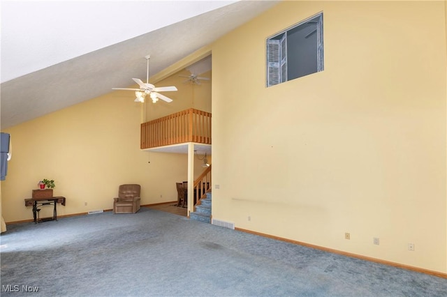 unfurnished living room featuring high vaulted ceiling, ceiling fan, and carpet