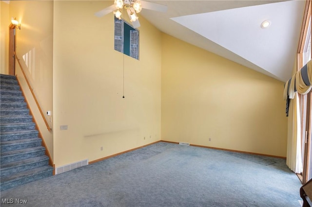 interior space with ceiling fan, lofted ceiling, and carpet flooring