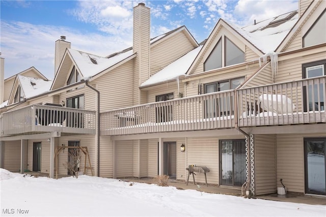 snow covered house with a balcony