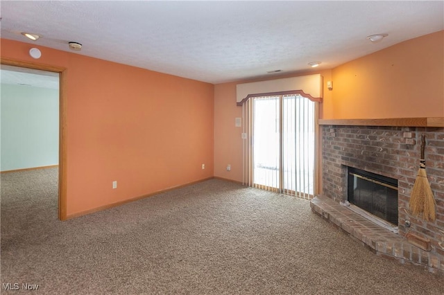 unfurnished living room featuring a fireplace, carpet floors, and a textured ceiling