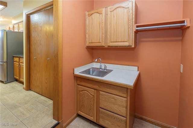 kitchen featuring sink and stainless steel fridge