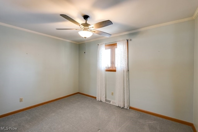 spare room featuring crown molding, ceiling fan, and carpet