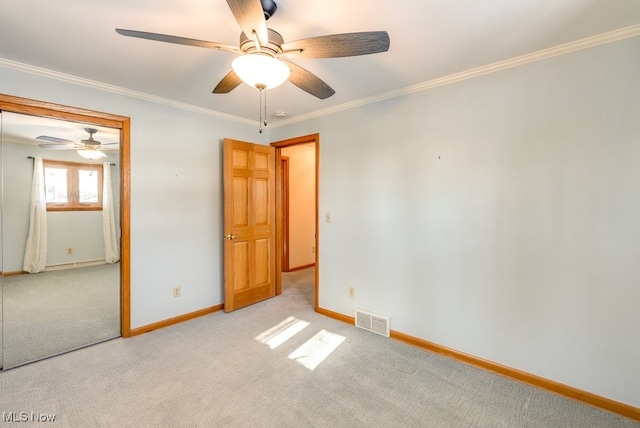 unfurnished room featuring ornamental molding and light colored carpet