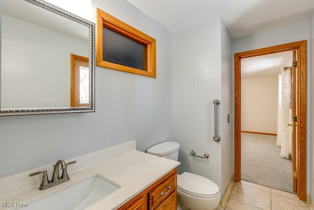 bathroom with tile patterned floors, vanity, and toilet