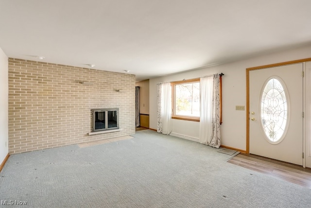 interior space featuring brick wall and a brick fireplace