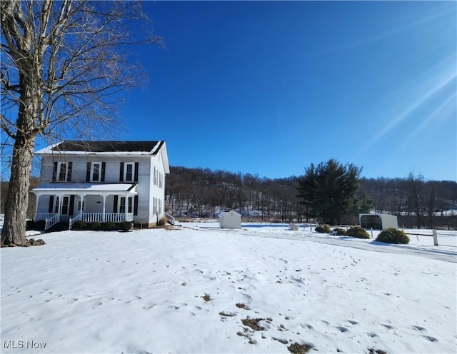 yard layered in snow with covered porch