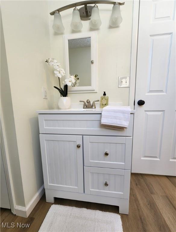 bathroom with vanity and hardwood / wood-style floors