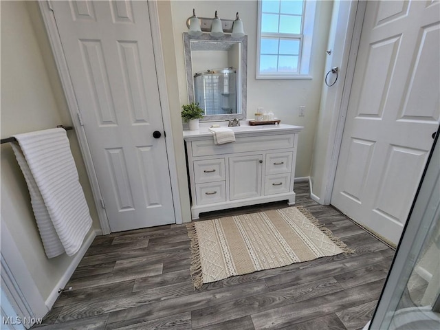 bathroom with vanity, wood-type flooring, and a shower with shower door