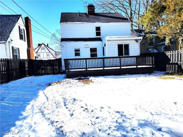 snow covered property featuring a deck