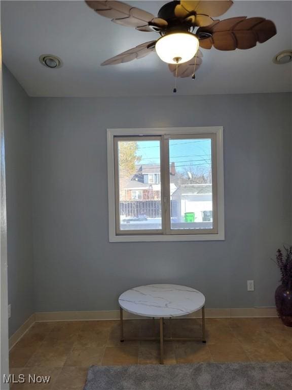 sitting room featuring light tile patterned floors and ceiling fan