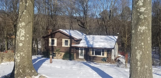 view of snow covered rear of property