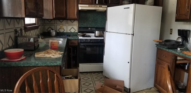 kitchen with dark brown cabinetry, backsplash, and white appliances