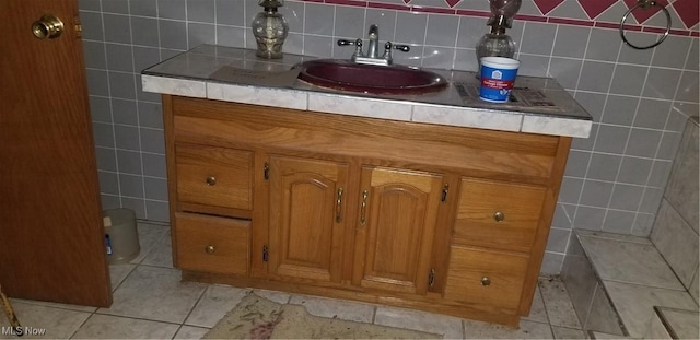 bathroom with vanity and tile walls