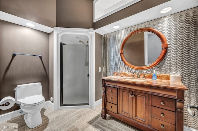 bathroom with vanity, an enclosed shower, and toilet