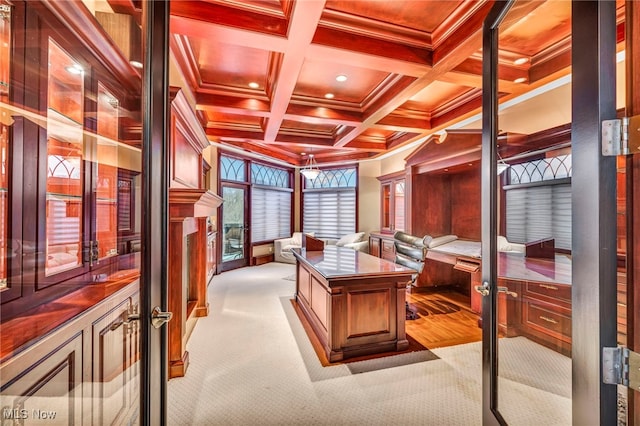 carpeted office space featuring ornamental molding, coffered ceiling, and beam ceiling