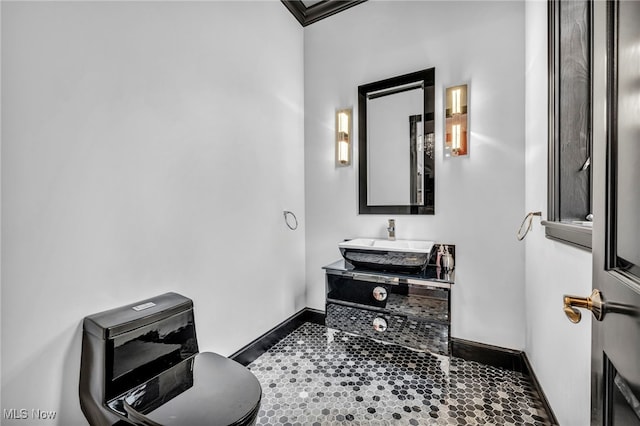 bathroom featuring vanity, crown molding, and toilet