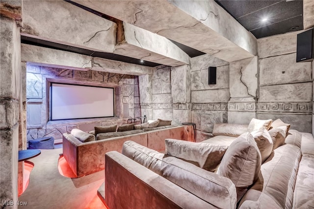 home theater room featuring concrete floors