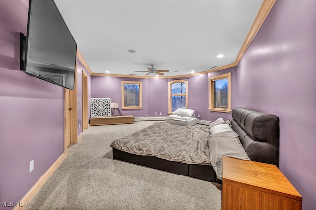 bedroom with a baseboard heating unit, crown molding, carpet floors, and ceiling fan