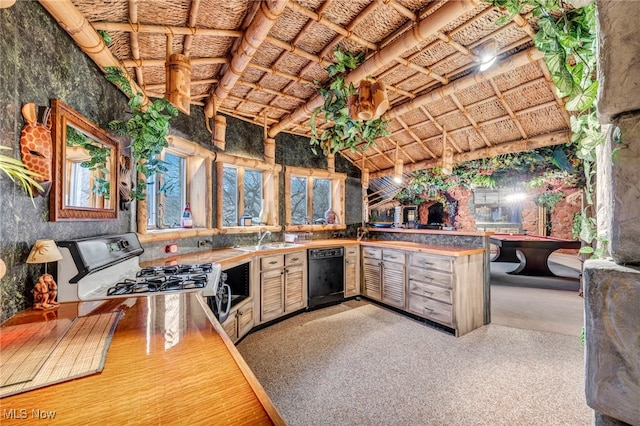 kitchen featuring sink, range, black dishwasher, a high ceiling, and kitchen peninsula