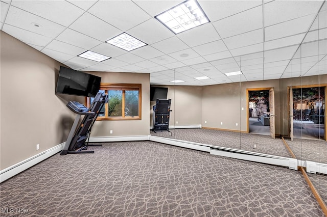 workout area featuring a baseboard radiator and a drop ceiling