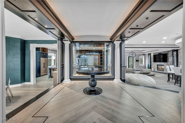 interior space with ornamental molding and ornate columns