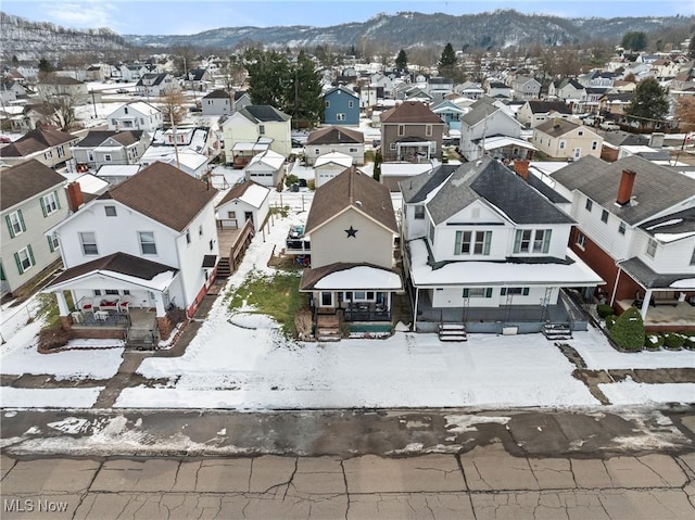 snowy aerial view featuring a mountain view