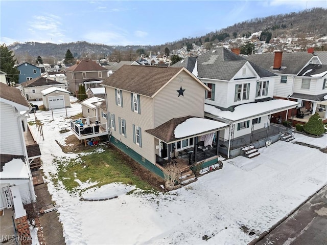 snowy aerial view with a mountain view