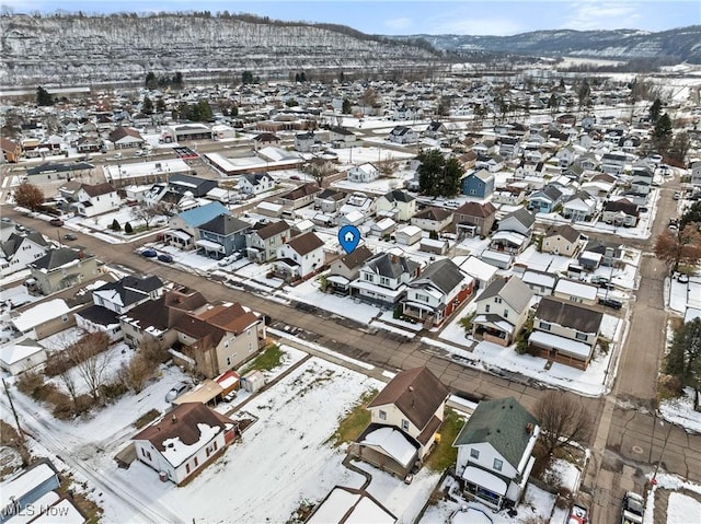 snowy aerial view with a mountain view