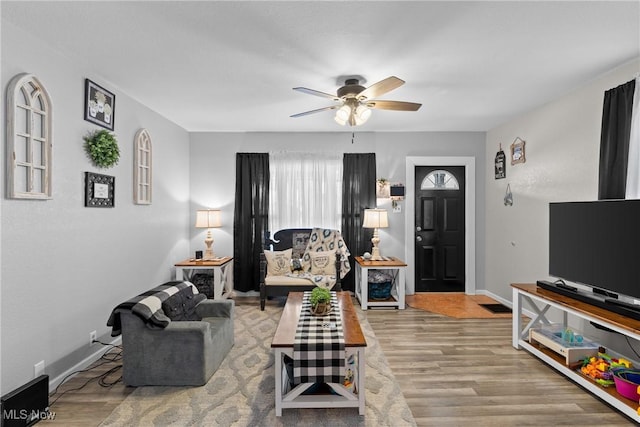 living room featuring ceiling fan and light wood-type flooring