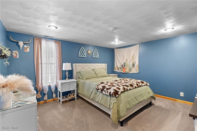 carpeted bedroom with a textured ceiling