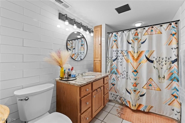 bathroom with a shower with curtain, vanity, toilet, and tile patterned flooring