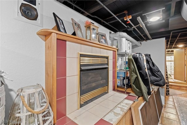 interior space with a tiled fireplace