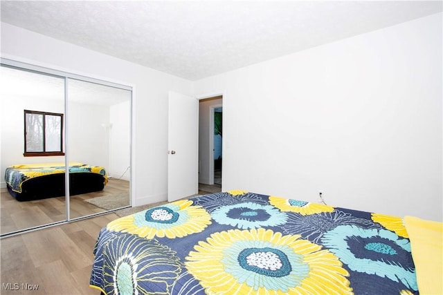 bedroom featuring a closet and wood finished floors