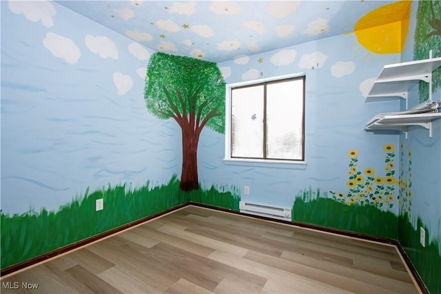 unfurnished room featuring a baseboard radiator and hardwood / wood-style floors