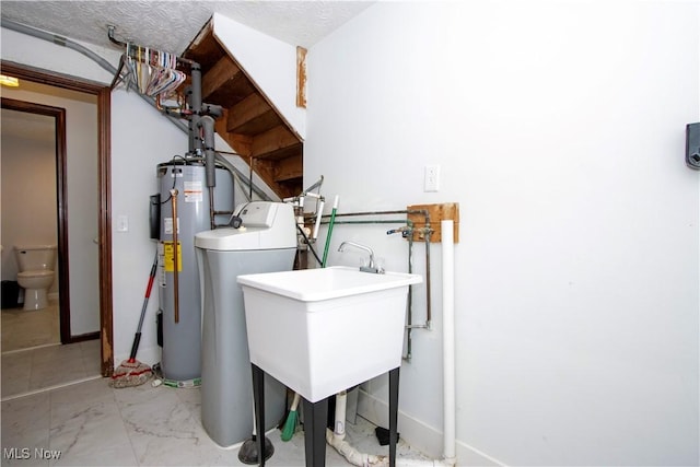 utilities featuring water heater and a sink