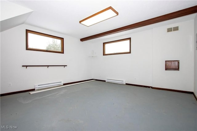 spare room featuring a baseboard heating unit, a healthy amount of sunlight, visible vents, and concrete floors