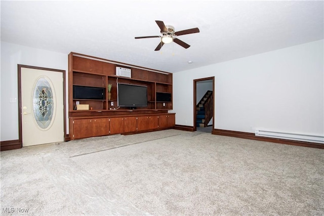 unfurnished living room featuring light carpet, baseboards, a ceiling fan, a baseboard radiator, and stairway