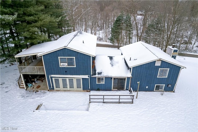 view of snow covered rear of property