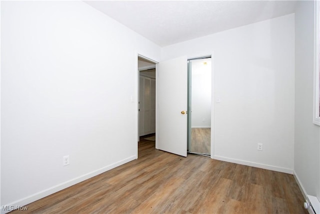 unfurnished bedroom with light wood finished floors and baseboards