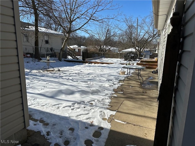 view of yard layered in snow