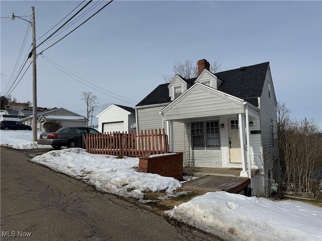 view of front facade featuring an outbuilding and a garage