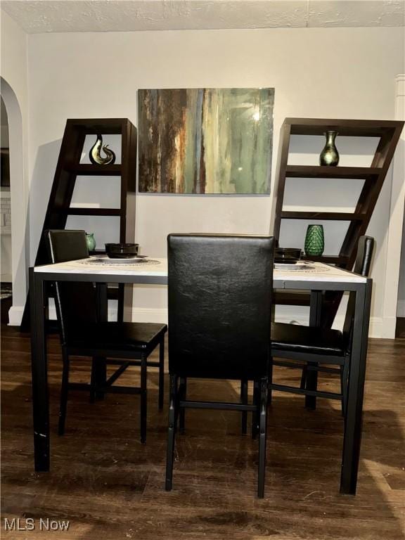 dining area with dark hardwood / wood-style floors