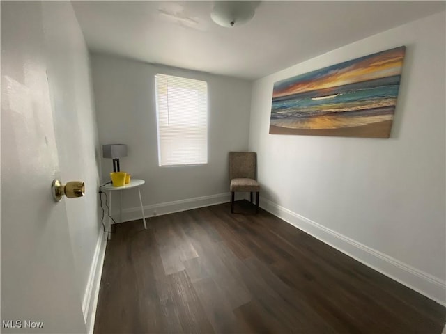 unfurnished room with dark hardwood / wood-style flooring