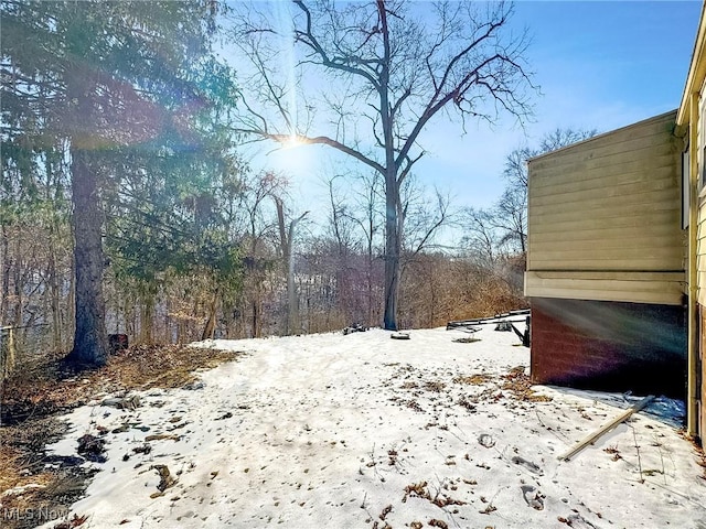 view of yard layered in snow