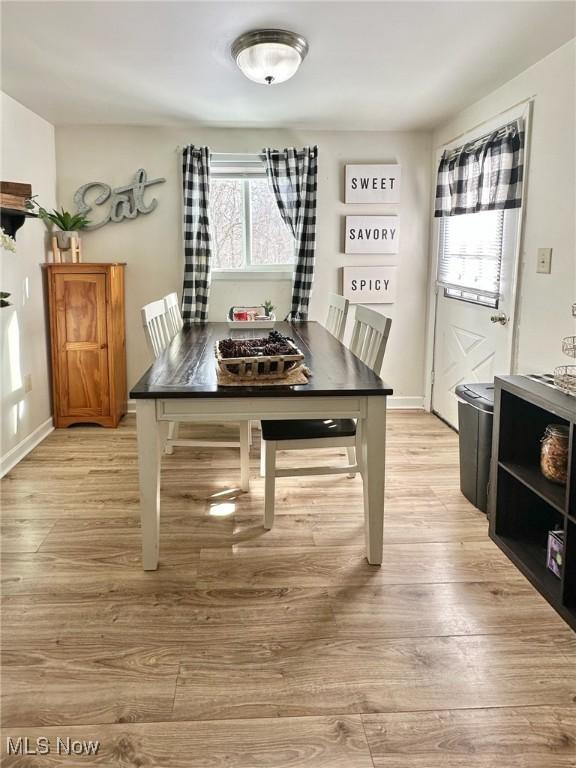 dining space with light hardwood / wood-style floors