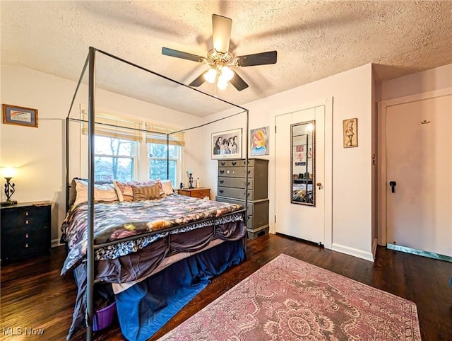 bedroom featuring ceiling fan, dark hardwood / wood-style flooring, and a textured ceiling