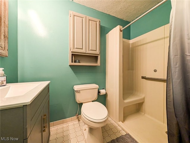 bathroom with vanity, toilet, a textured ceiling, and a shower with shower curtain