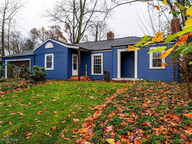 single story home featuring a garage and a front yard