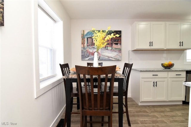 dining room featuring light wood-type flooring and visible vents